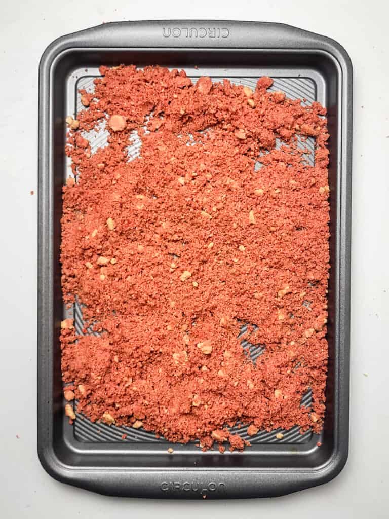 prebaked strawberry crunch topping for for strawberry crunch cheesecake on baking sheet