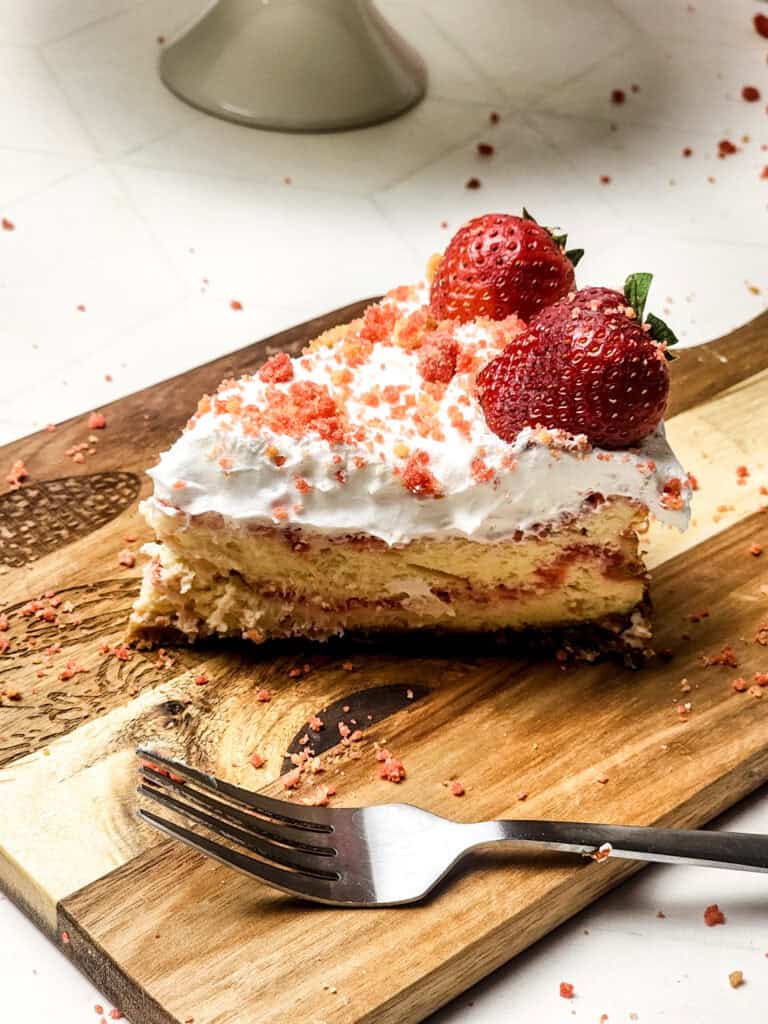 slice of strawberry crunch cheesecake side view