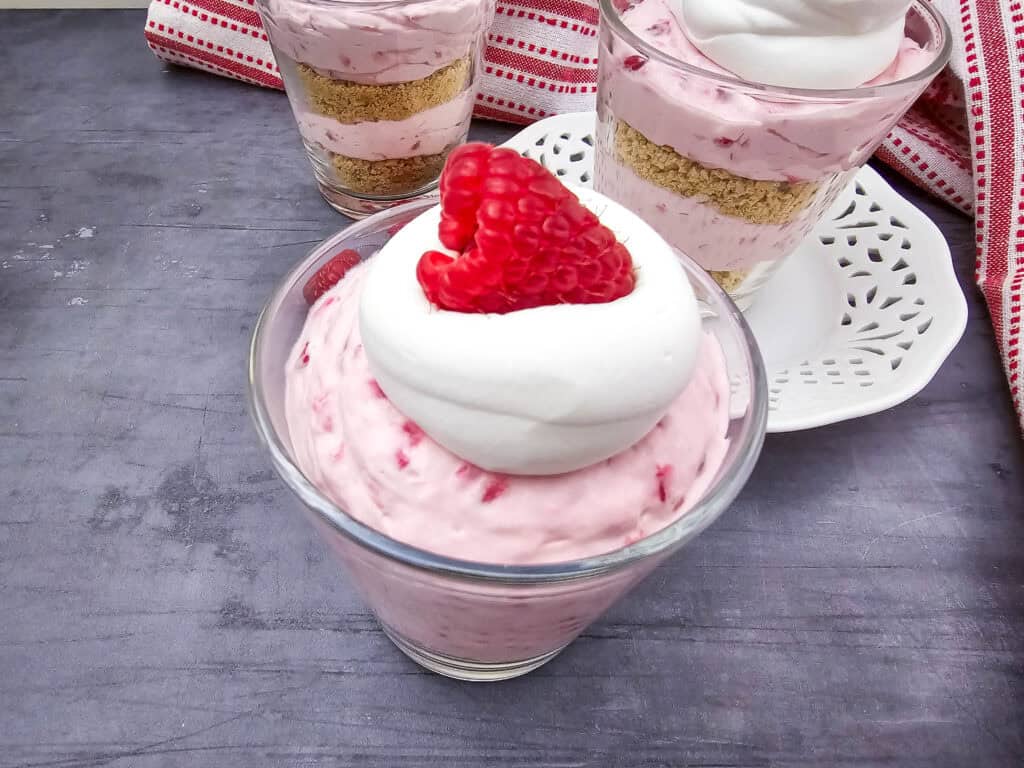 no bake raspberry cheesecake parfaits in a glass closeup