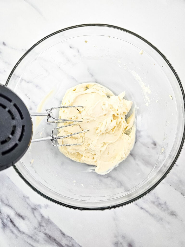 mixing creamcheese base for no bake raspberry cheesecake parfait