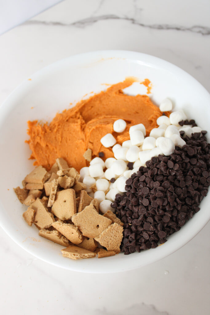 Pumpkin cookie dough mixed with graham cracker pieces, mini marshmallows, and chocolate chips.